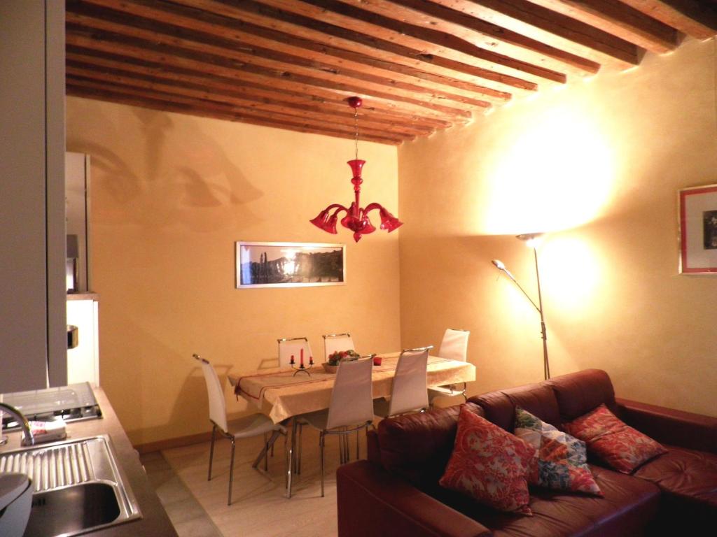 een woonkamer met een tafel en een bank bij Ca' Delle Maschere in Venetië