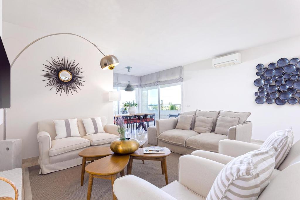 a living room with white furniture and a table at Genteel Home Flamencos Terrace in Marbella