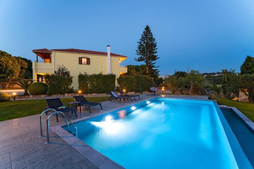 a swimming pool in front of a house at Villa Iasama in Rhodes Town