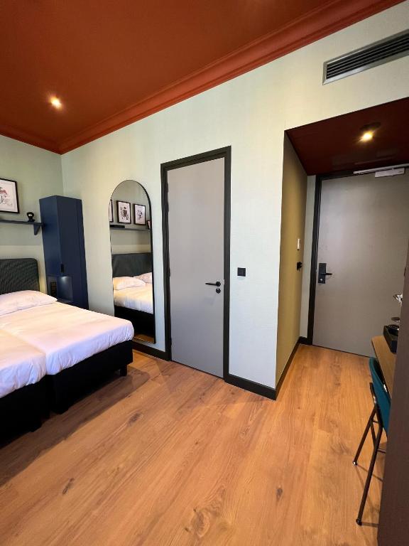 Postel nebo postele na pokoji v ubytování Hotel Nicolaas Witsen
