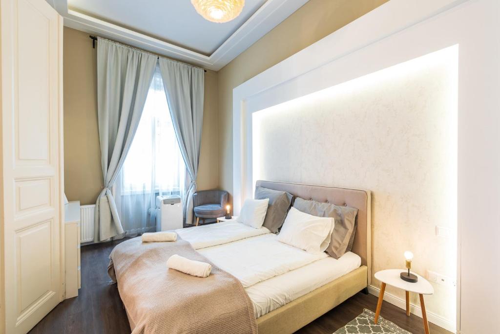 a bedroom with a bed with a large window at Spacious Luxury apartment at the heart of Budapest in Budapest