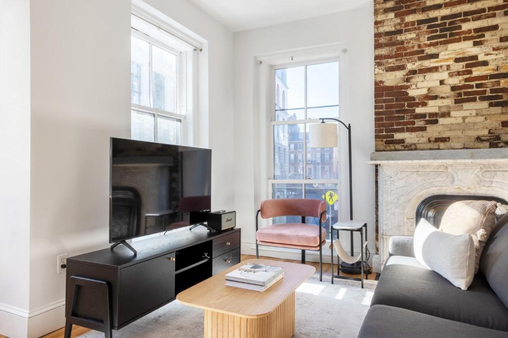 a living room with a couch and a fireplace at Beacon Hill 2br w wd nr Boston Common BOS-826 in Boston