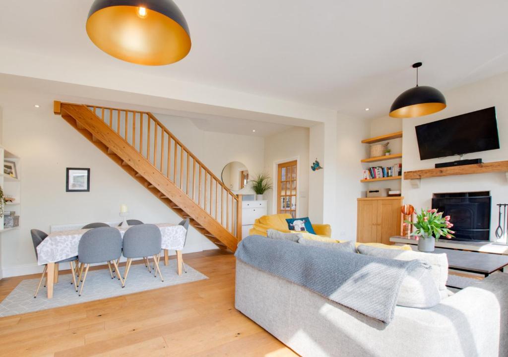 a living room with a couch and a table at Honey Cottage in Richmond