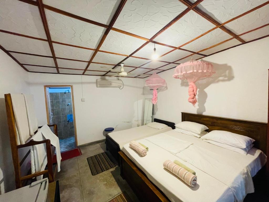 Postel nebo postele na pokoji v ubytování Mangala Lodge