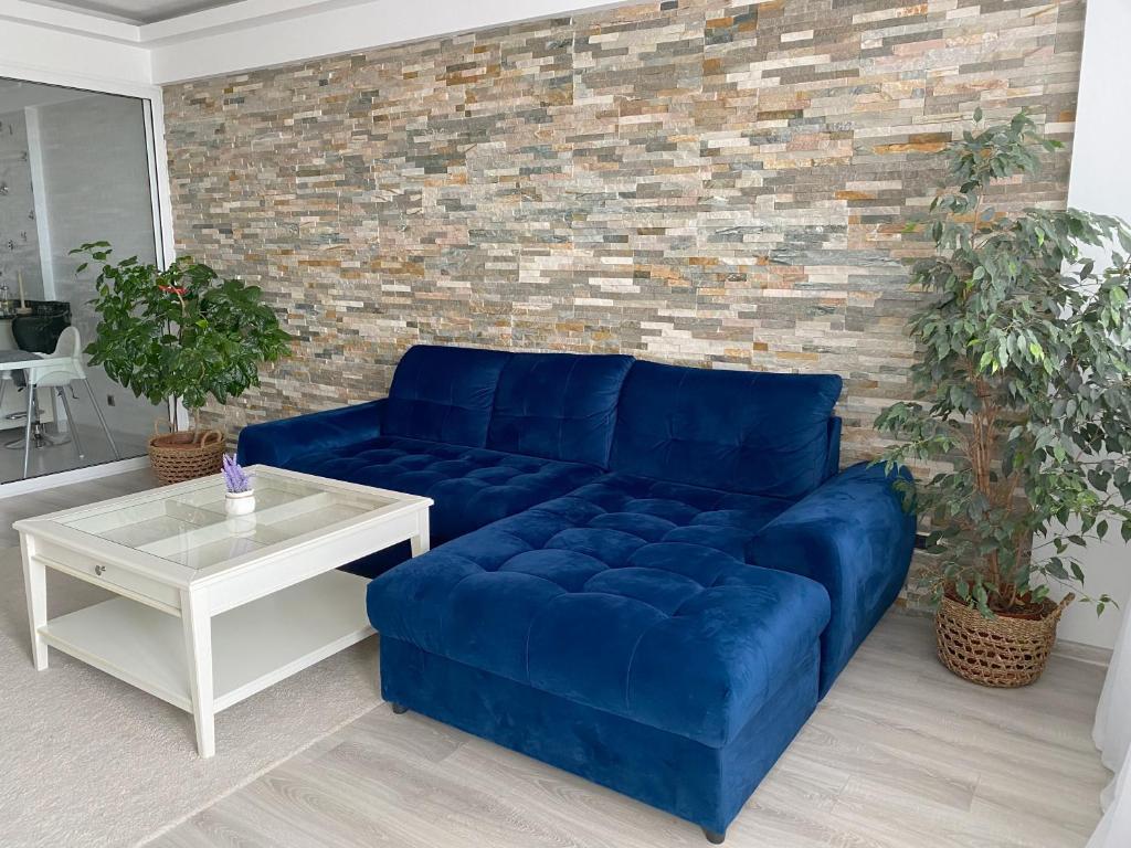 un canapé bleu devant un mur de briques dans l'établissement Untold Panoramic View, à Braşov