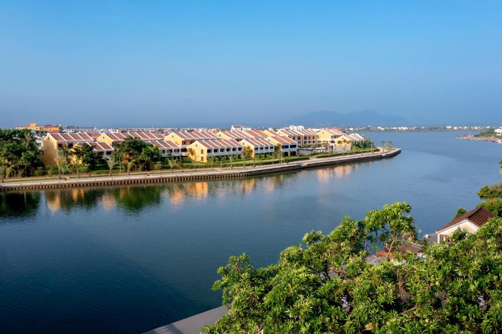 Vista ariale di un fiume con case sulla riva di BAY RESORT HOI AN a Hoi An