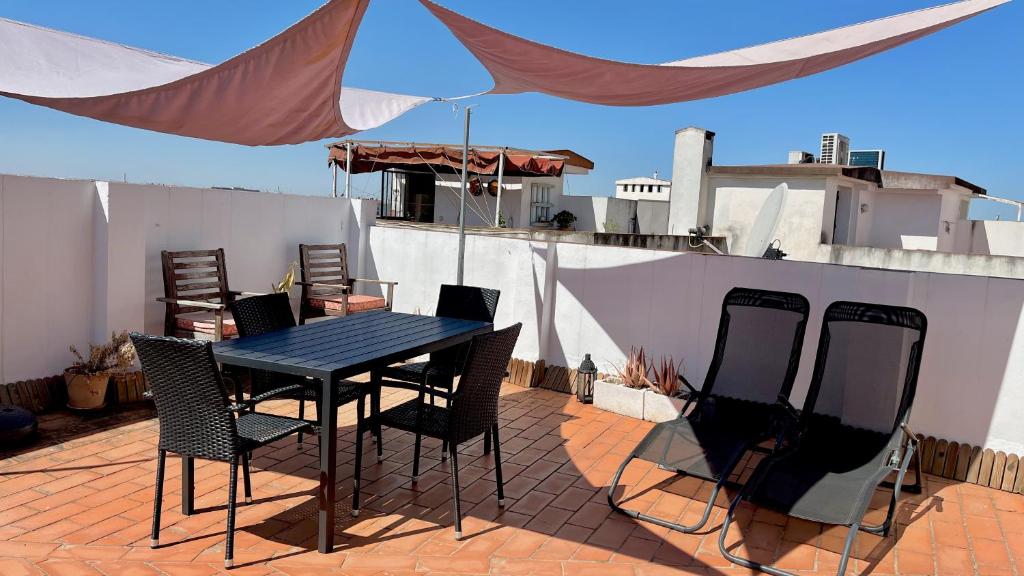 einen Tisch und Stühle auf einer Terrasse in der Unterkunft El Mirador de la Judería in Córdoba