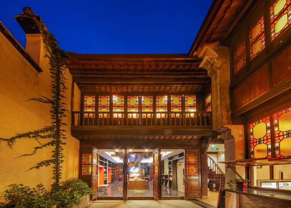 a building with a large building with a balcony at WuZhen Dream Hotel in Tongxiang