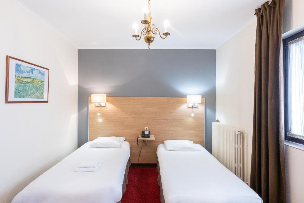 Postel nebo postele na pokoji v ubytování Hôtel du Helder
