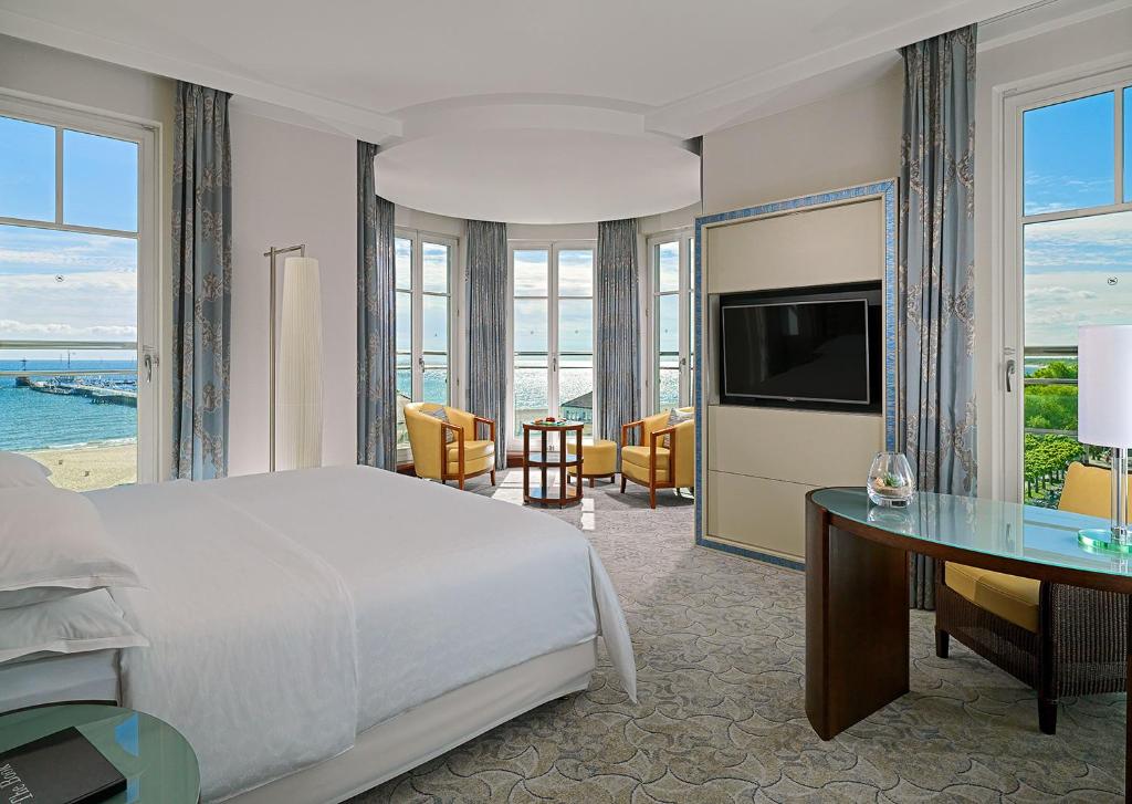 a bedroom with a bed and a desk and a television at Sheraton Sopot Hotel in Sopot