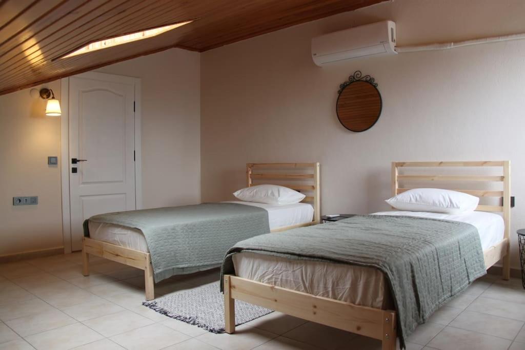 a bedroom with two beds and a window at Kaya Suite Sunrise in Fethiye