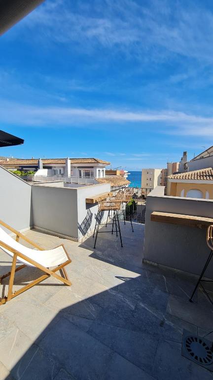 a patio with tables and chairs on a roof at Moraira Fantástico Ático Duplex in Moraira