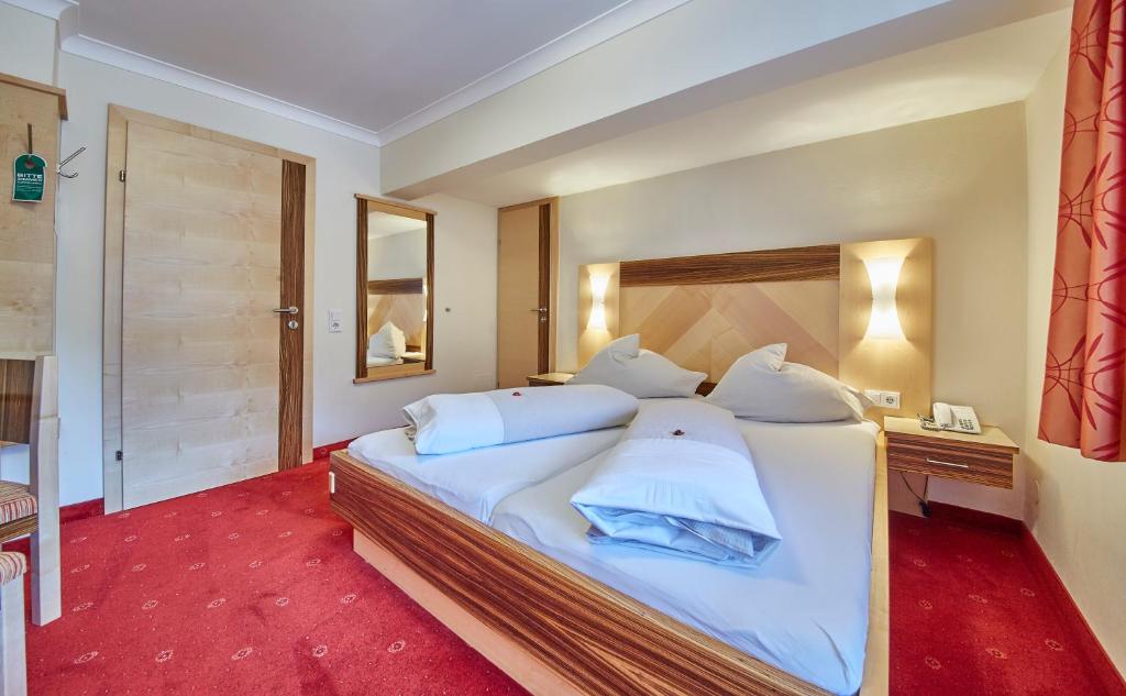 Postel nebo postele na pokoji v ubytování Apart-Hotel Forellenhof