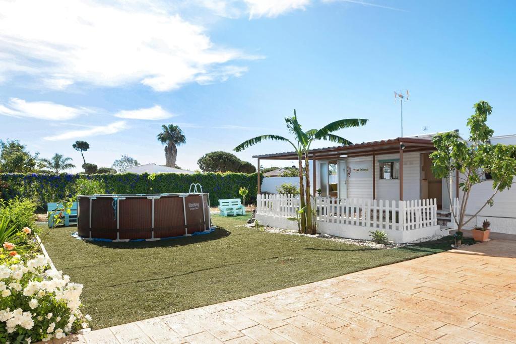 une maison avec une cour et un bain à remous dans l'établissement Villa Triana, à Chiclana de la Frontera