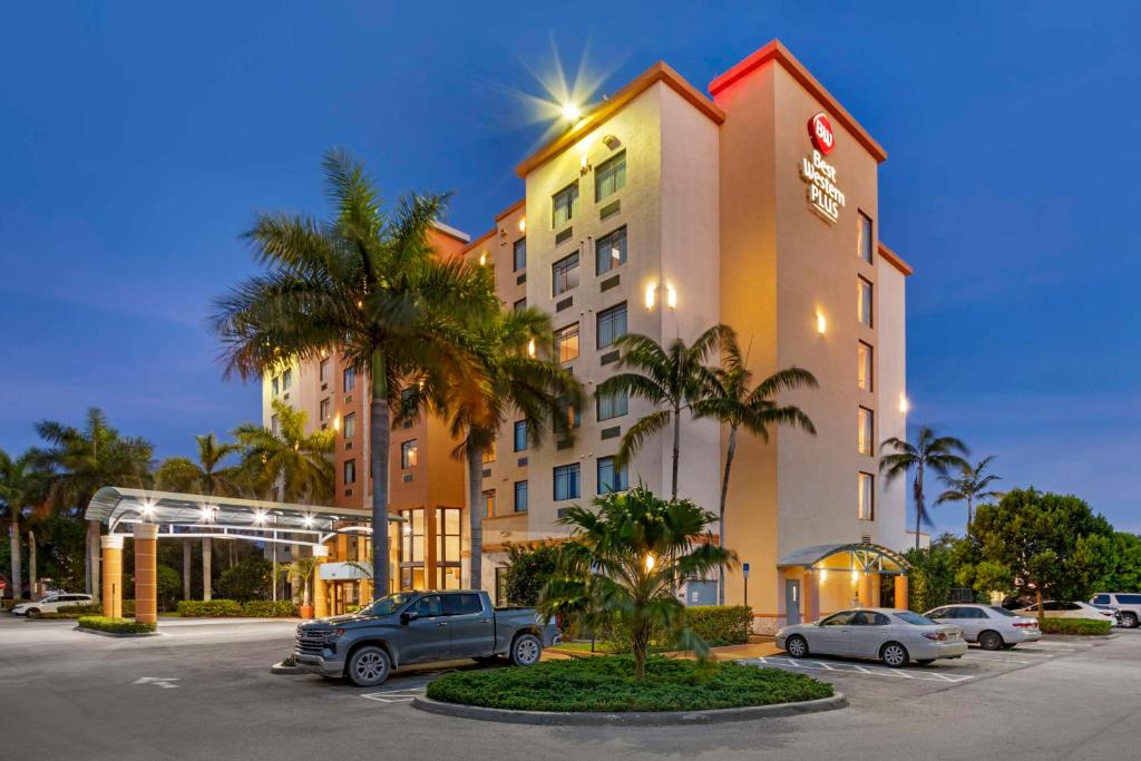 a hotel with a car parked in a parking lot at Best Western Plus Miami Executive Airport Hotel and Suites in Kendall