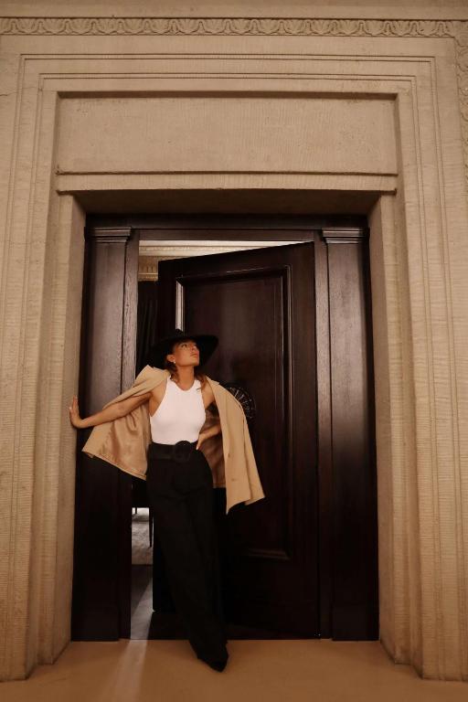 a woman is standing in front of a door at The Wellem, in The Unbound Collection by Hyatt in Düsseldorf