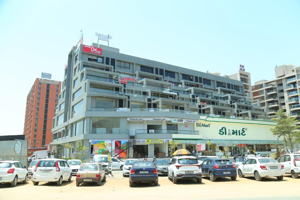 a parking lot full of cars in front of a building at HOTEL OM INN in Gandhinagar