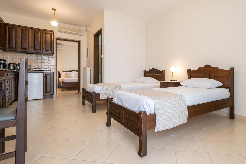 a living room with two beds and a kitchen at Amigdalies in Myrina