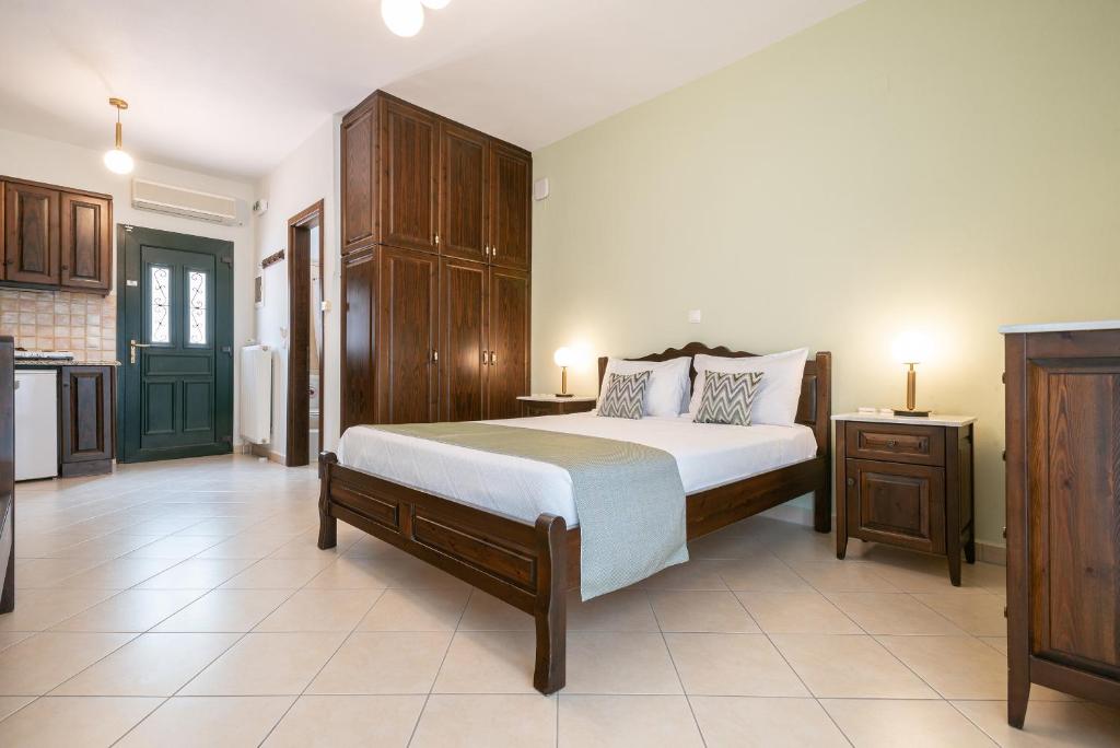 a bedroom with a bed and a kitchen at Amigdalies in Myrina