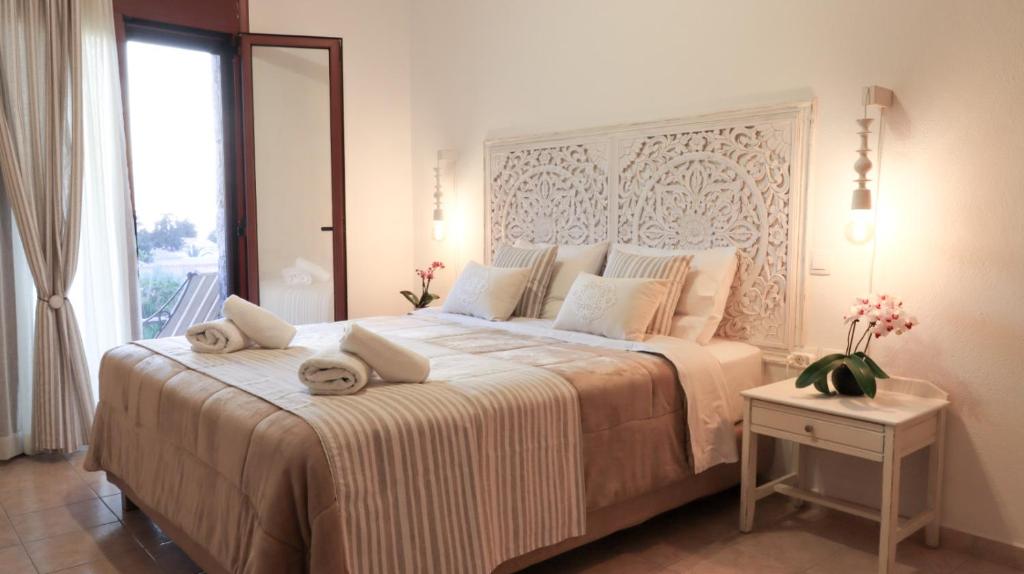 - une chambre avec un grand lit et des serviettes dans l'établissement Comfortable Apartment with Garden - Casa con Vista, à Chavania