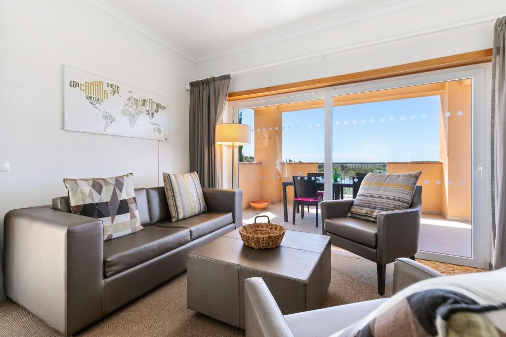 a living room with a couch and a table at Vale da Ribeira - Casa Serenidade in Mexilhoeira Grande