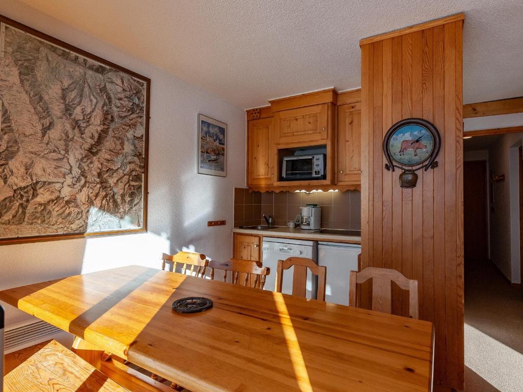 a kitchen with a wooden table and a dining room at Appartement Méribel, 3 pièces, 6 personnes - FR-1-355-48 in Méribel