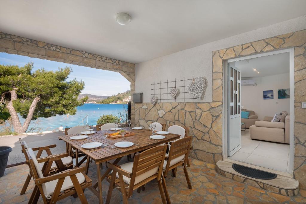 a dining room with a table and a view of the ocean at Estella Villa in Rogoznica