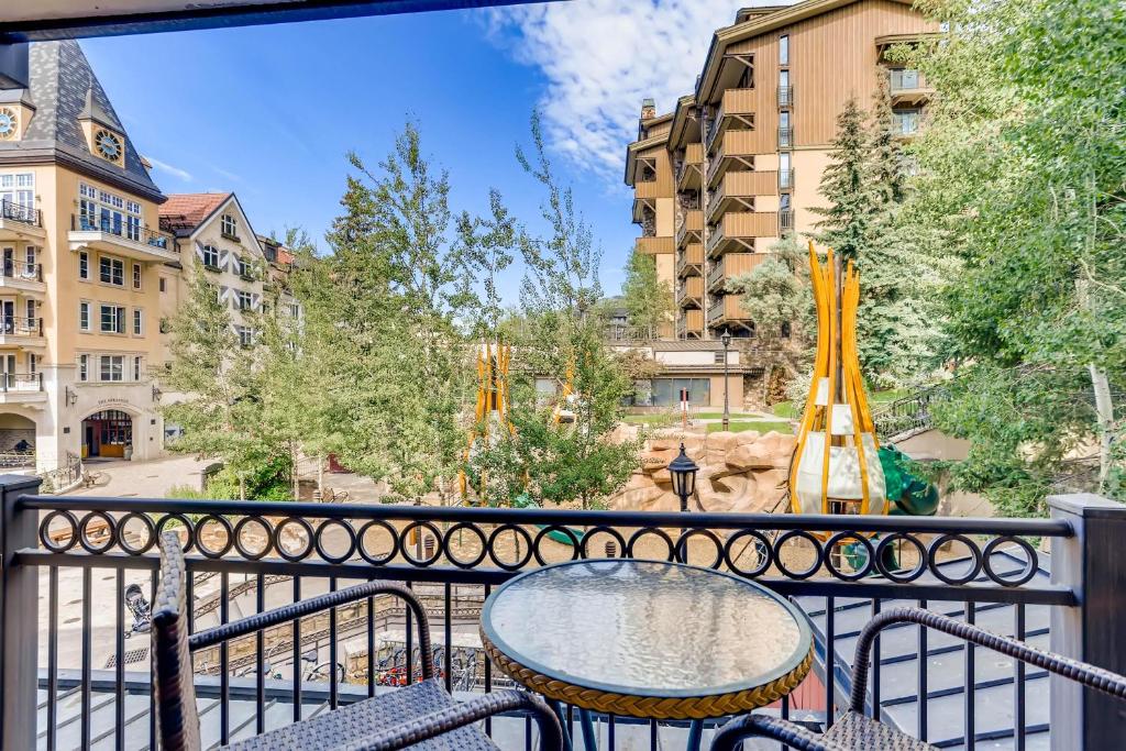 a table and chairs on a balcony with a playground at Lift House Lodge, Lionshead, Studio Condo in Vail