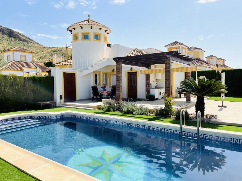 a house with a swimming pool in front of a house at Casa Buena Vista with private pool in Mazarrón