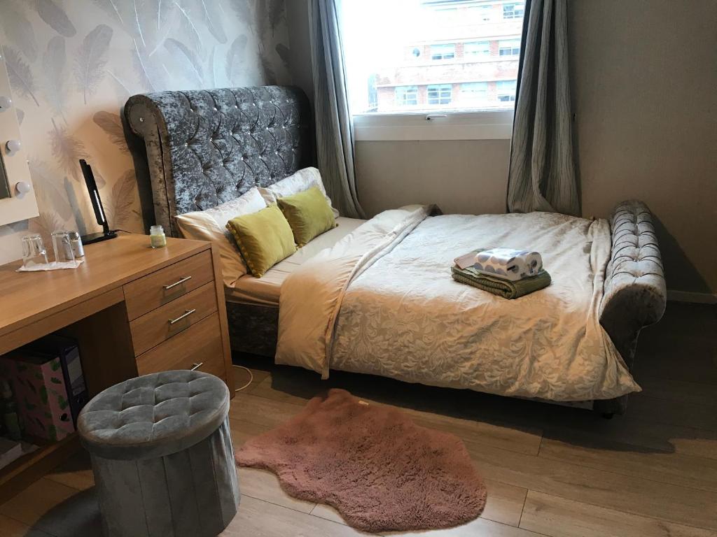 a bedroom with a bed and a desk and a window at Stoddart House in Newcastle upon Tyne