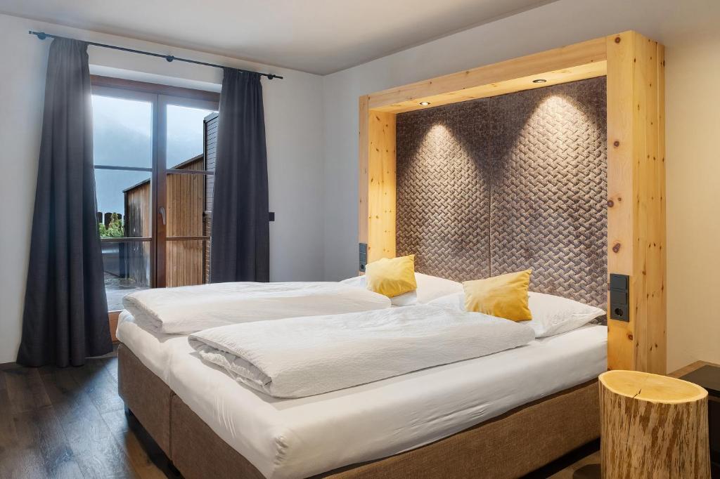 una camera da letto con un letto grande con testiera in legno di Angerle Alm Apt Similde A a Carezza al Lago