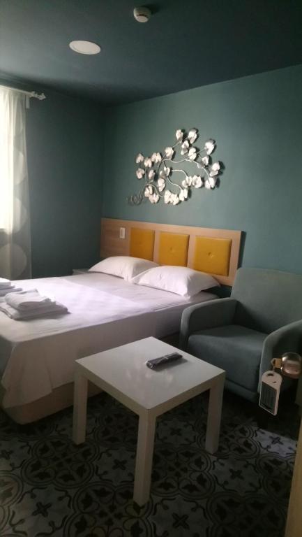 1 dormitorio con cama, sofá y mesa en 5RoomsPansiyon, en Edirne