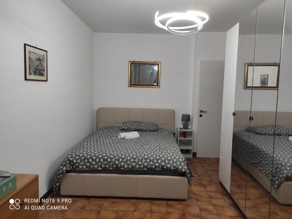 a bedroom with two beds and a mirror at Da FELICIA & Fabrizio in Rome