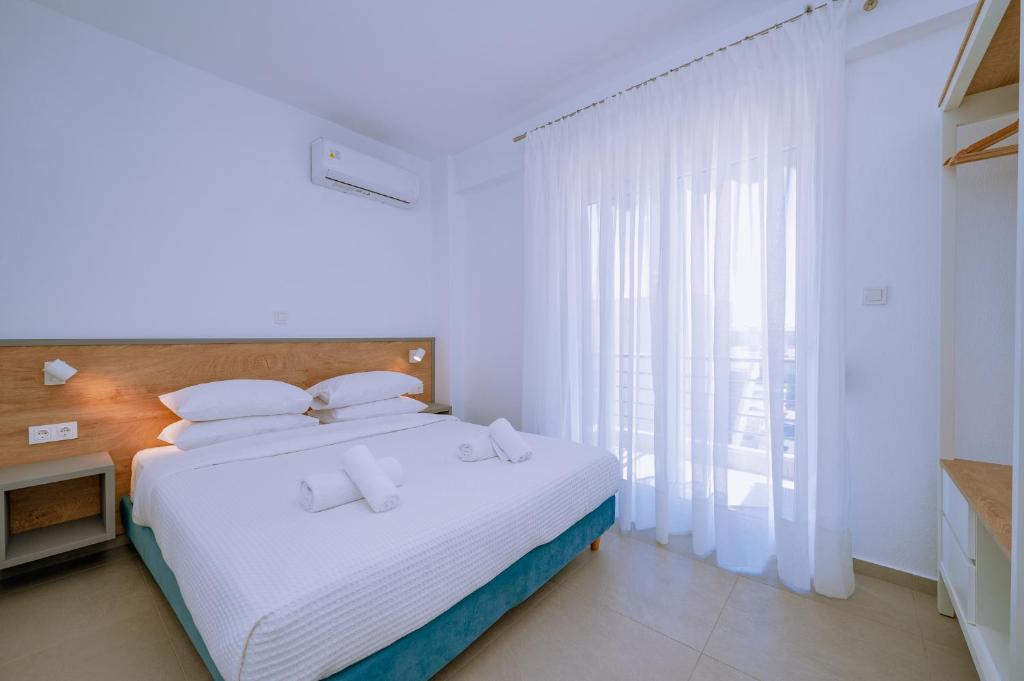 Postel nebo postele na pokoji v ubytování Danai & Palm Residential Complexes