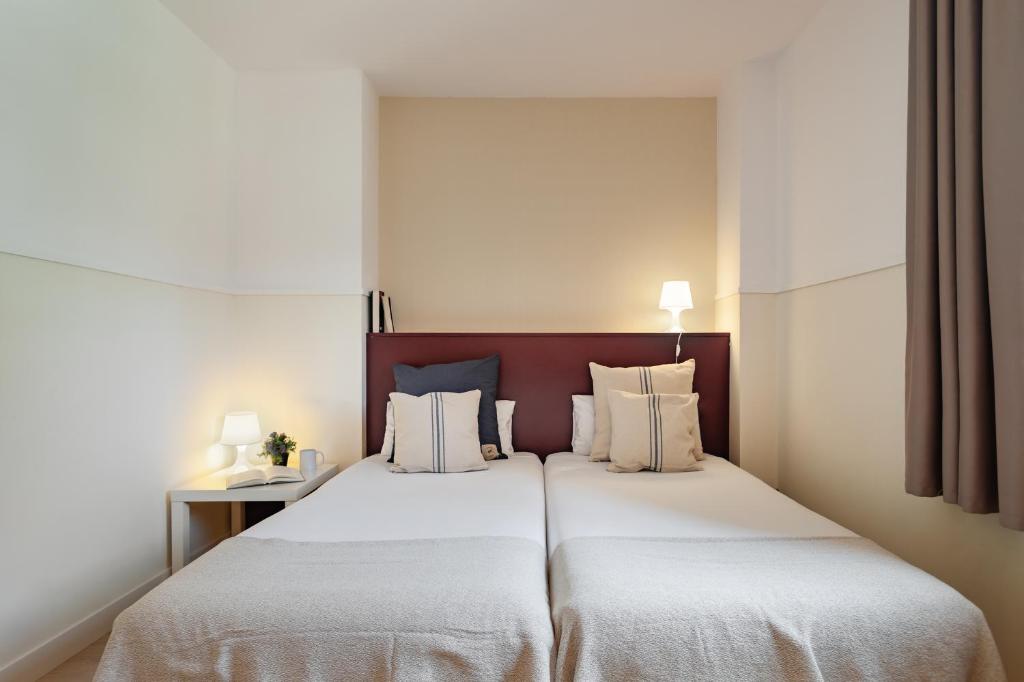 Posteľ alebo postele v izbe v ubytovaní Apartments Sata Olimpic Village Area