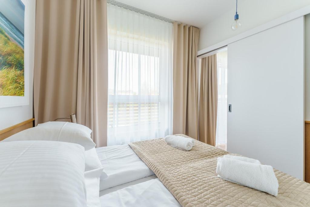 Posteľ alebo postele v izbe v ubytovaní Apartament DUNE SurfingBird Dźwirzyno