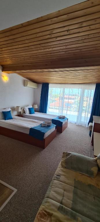 A bed or beds in a room at Mirana Family Hotel