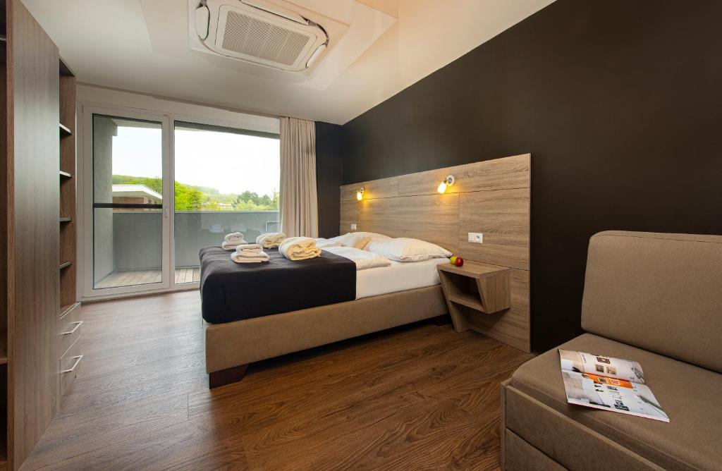 Postel nebo postele na pokoji v ubytování Residence Šírava ***