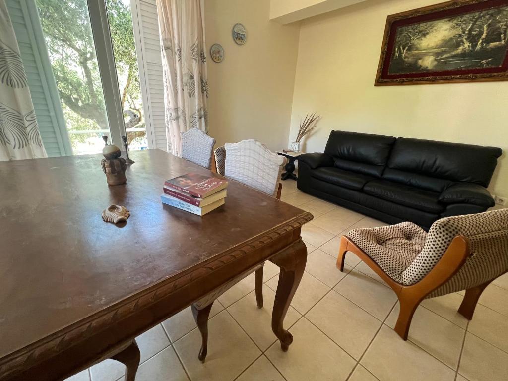 a living room with a wooden table and a couch at Lydia’s house in Argostoli
