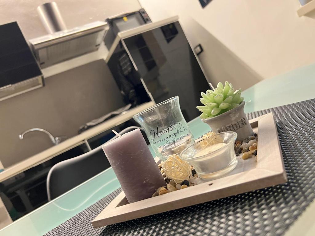 a tray with a clock and other items on a table at Abitare Ortigia in Siracusa