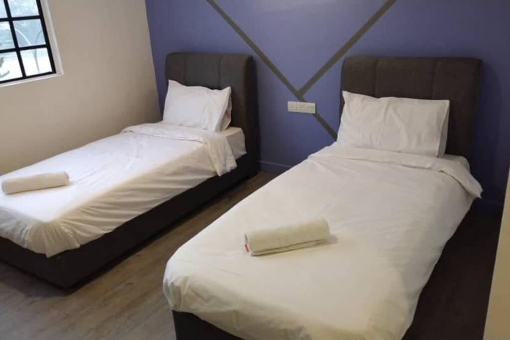 Ένα ή περισσότερα κρεβάτια σε δωμάτιο στο Gohtong Jaya SureWin Hotel