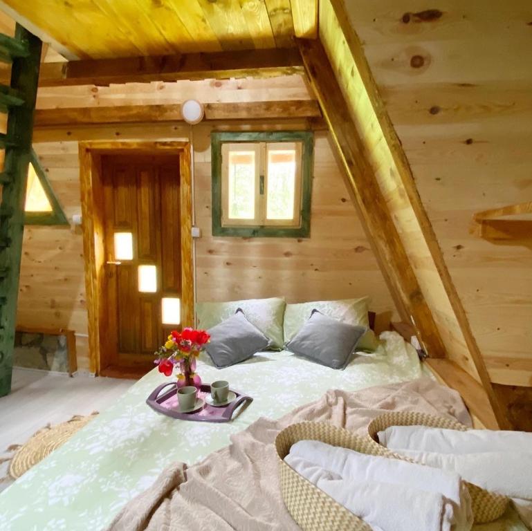 a bedroom with a bed in a log cabin at Eco kutak 2 in Mojkovac