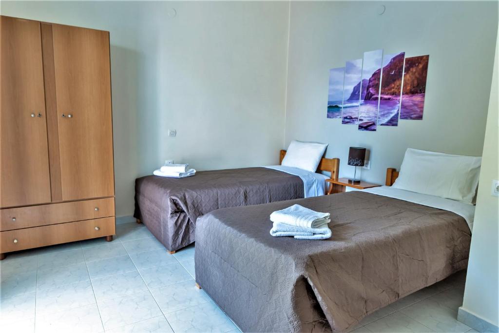 Postel nebo postele na pokoji v ubytování Zois Apartments