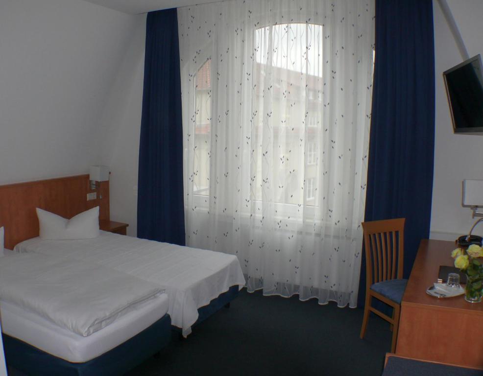 Postel nebo postele na pokoji v ubytování Hotel Garni - Haus Gemmer