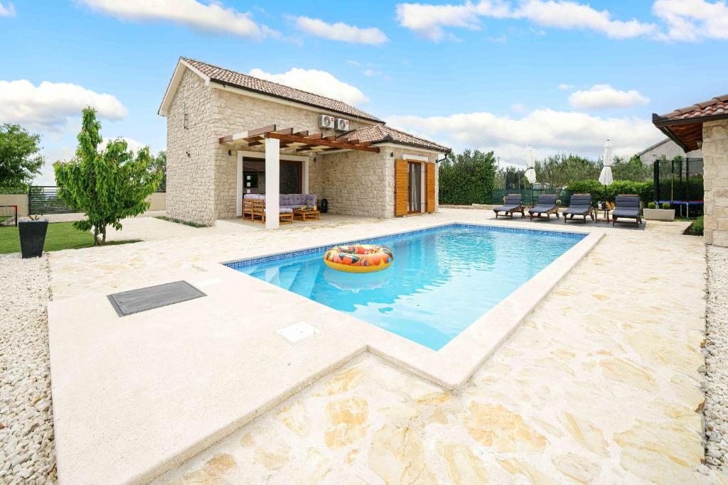 a swimming pool with a raft in the middle at Villa Lucia in Skradin