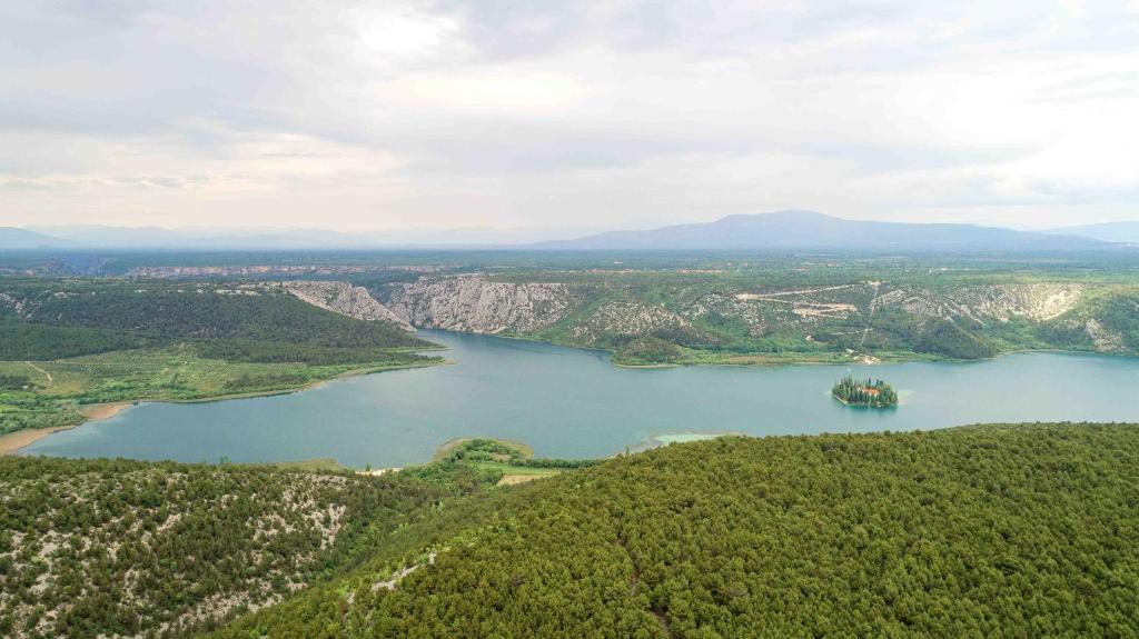 an aerial view of a large lake with a ship in it at Villa Lucia in Skradin