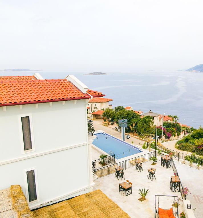 a view from the balcony of a house with a swimming pool at Gümüş Yazar Hotel in Kaş