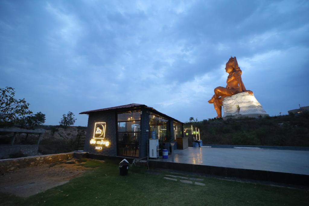 a small building with a statue in the background at The Sky Comfort Shiv Ashray Resort in Nāthdwāra