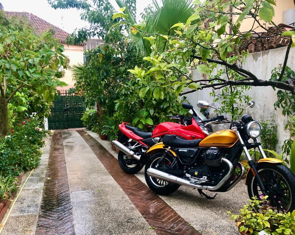 a red and yellow motorcycle parked next to a wall at Casa Bea B&B in Tortolì