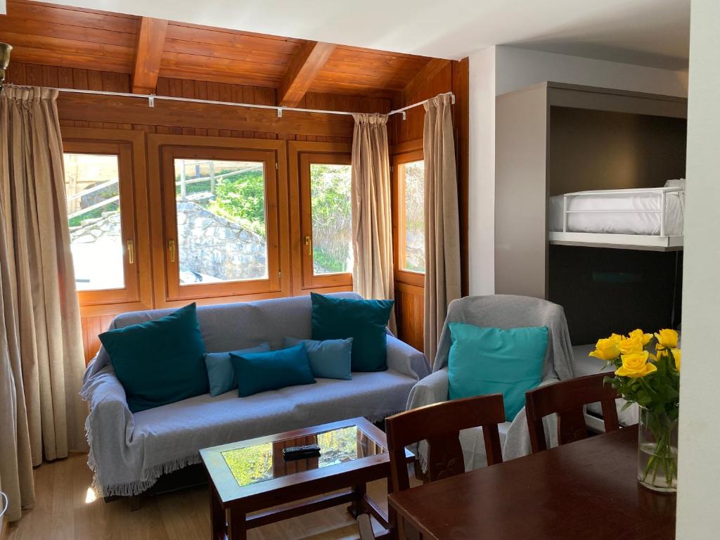 a living room with a couch and a table at El Diamante Soldeu in Soldeu